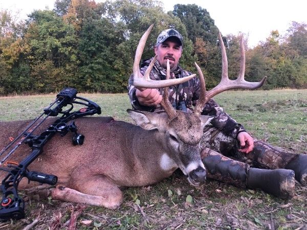 Man with buck from archery hunt